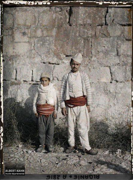 two people standing near a wall